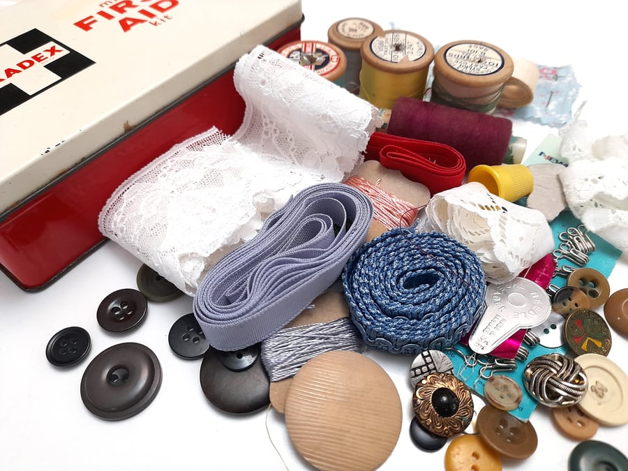 Vintage sewing haberdashery kit in an old first aid supplies tin