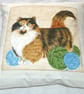 Pretty Tortoiseshell and white cat with balls of wool cushion - Image 1