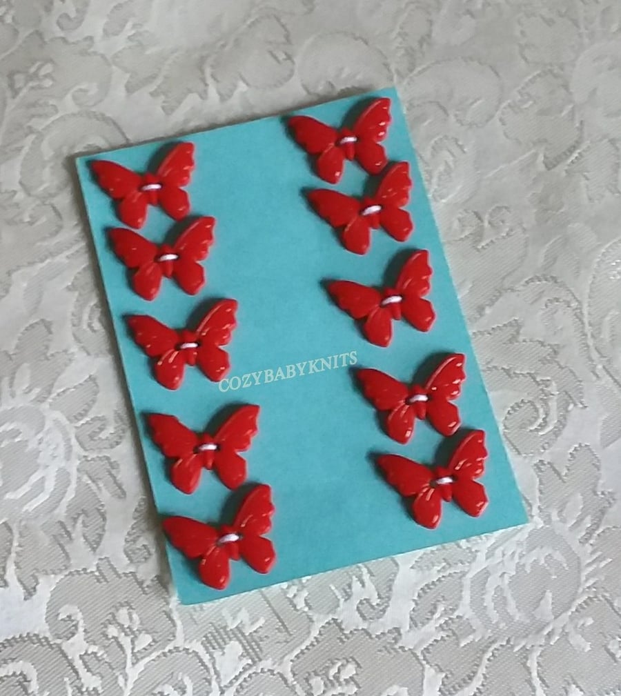RED PLASTIC BUTTERFLY BUTTONS WITH TWO HOLES FOR ATTACHING 