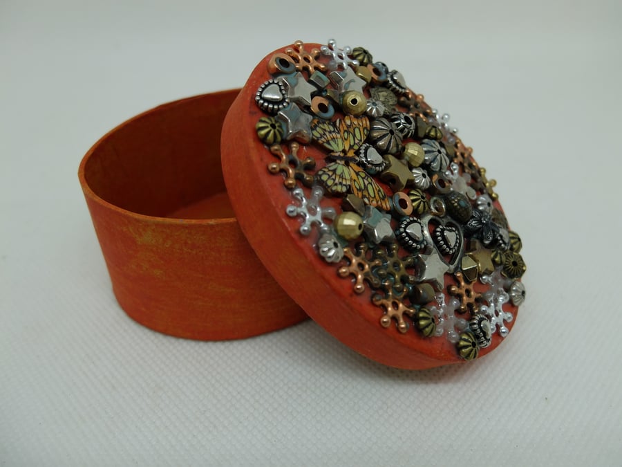 small oval cardboard gift box in orange with applied beads