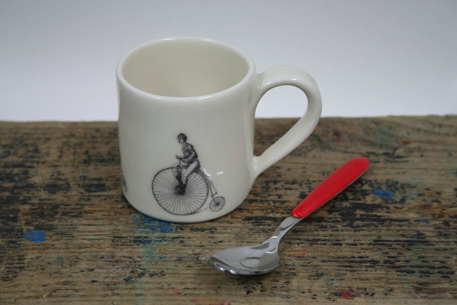Small porcelain mug with penny farthing image