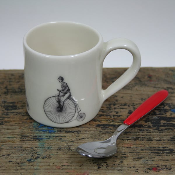 Small porcelain mug with penny farthing image
