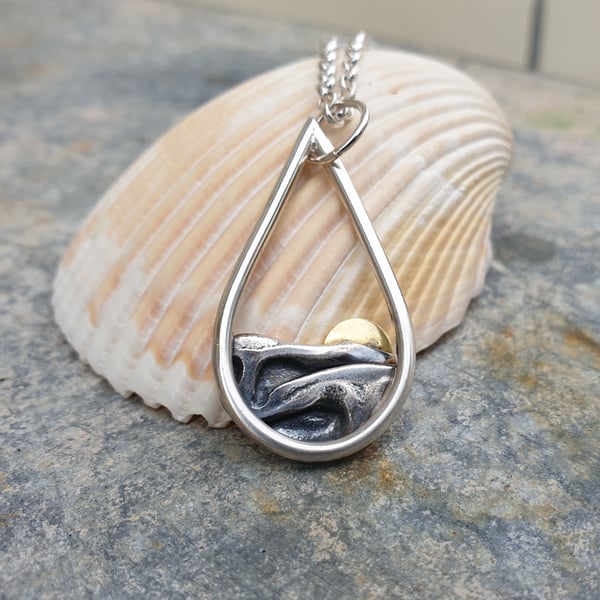 Silver sun rising over sea pendant