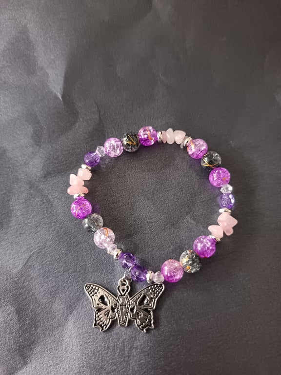 Elasticated pastel goth beaded bracelet with skull and butterfly charm
