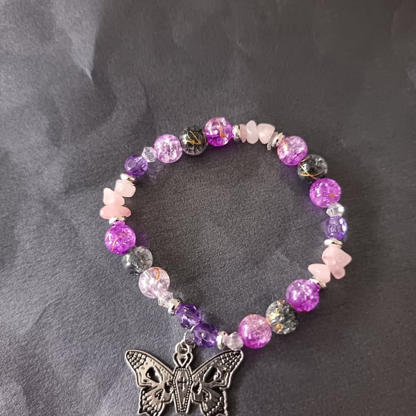 Elasticated pastel goth beaded bracelet with skull and butterfly charm