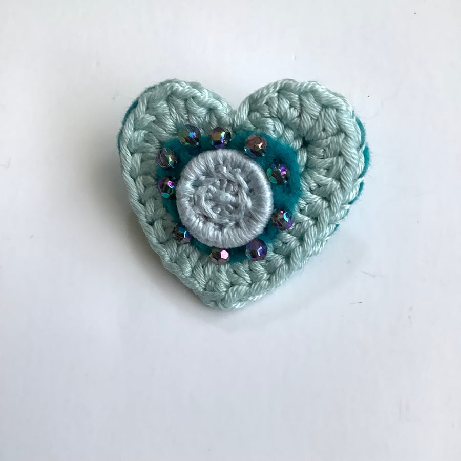 Crochet heart brooch with felt, beads and a Dorset button