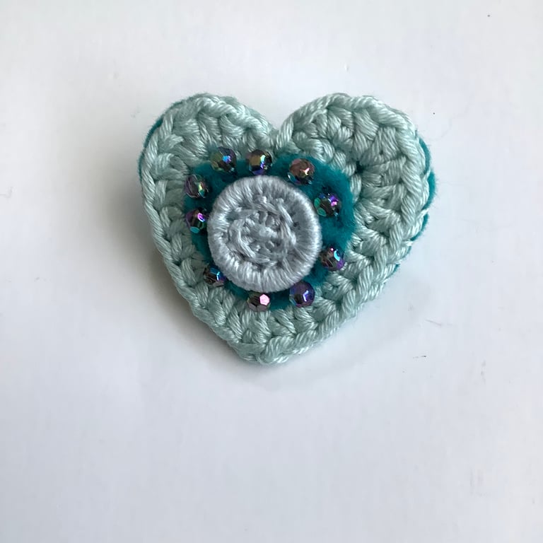 Crochet heart brooch with felt, beads and a Dorset button