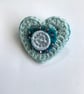 Crochet heart brooch with felt, beads and a Dorset button