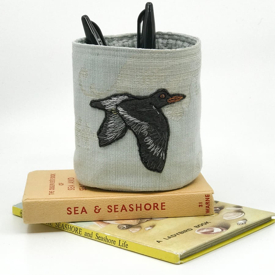 Textile storage pot with hand embroidered oystercatcher 