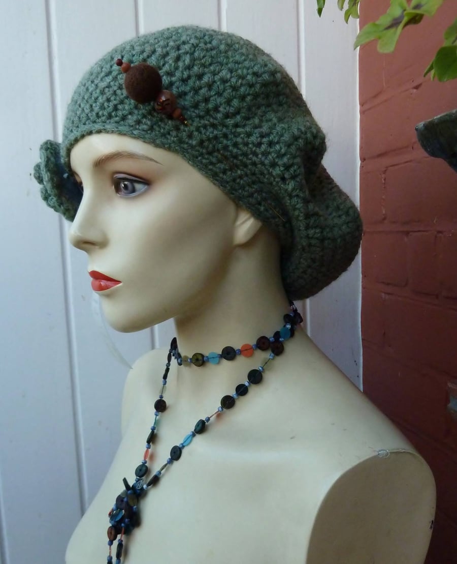 Crochet Beret in a soft sage green with a detachable brooch corsage.