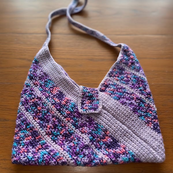 Handmade Crochet shoulder bag made from multicoloured purple wool.