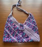 Handmade Crochet shoulder bag made from multicoloured purple wool.