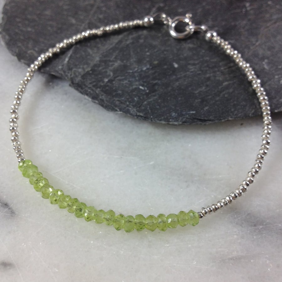 Silver friendship bracelet with faceted peridot gemstones