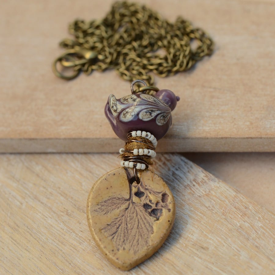 Mustard Ceramic Leaf Pendant Necklace with Purple Lampwork Glass Bird