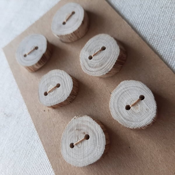 A set of six pale flat driftwood buttons