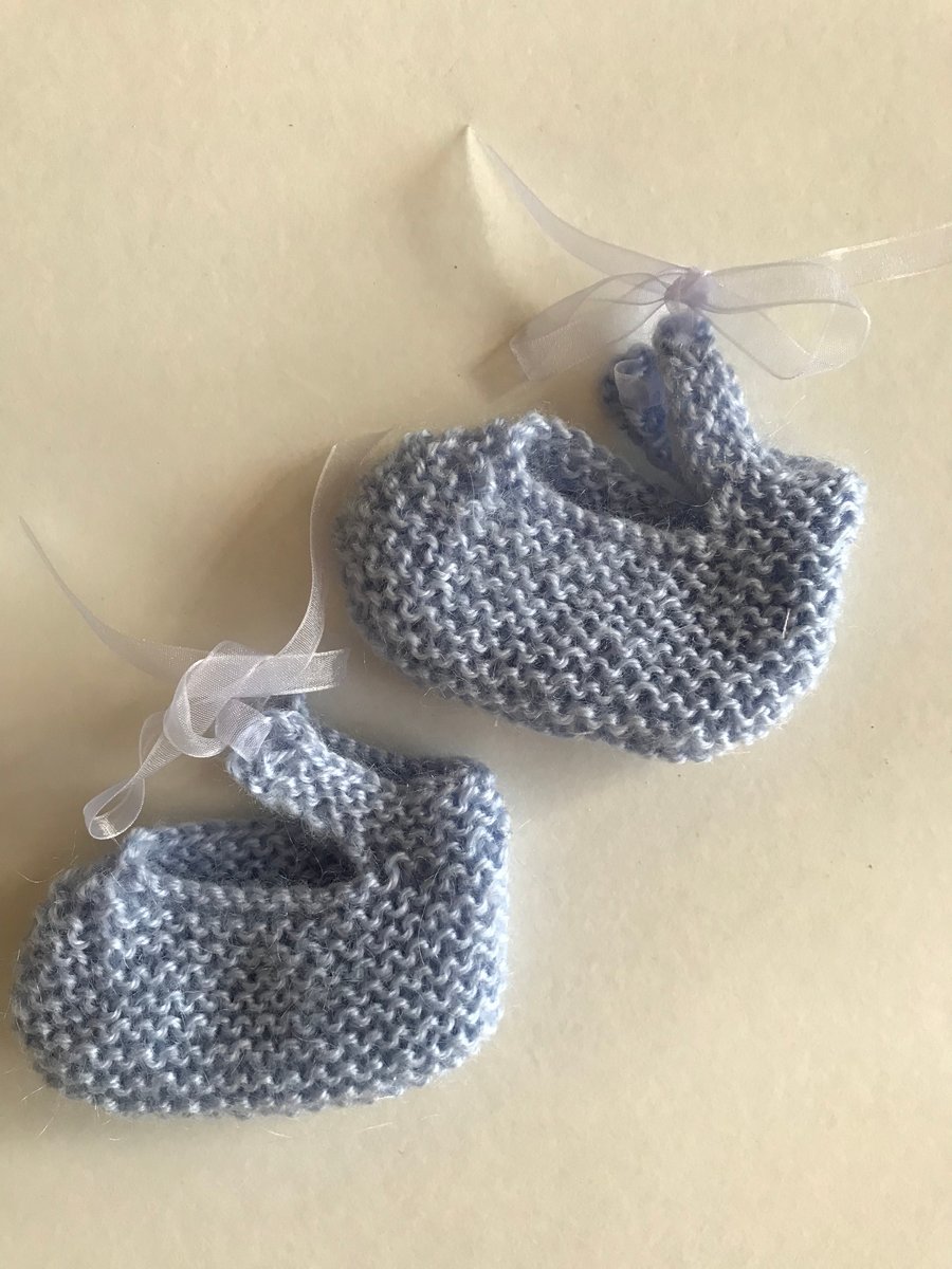 Little shoes hand knitted for a tiny baby