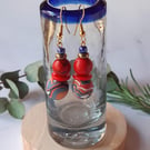 Handmade dangly polymer clay earrings  in red, blue and tangerine swirl