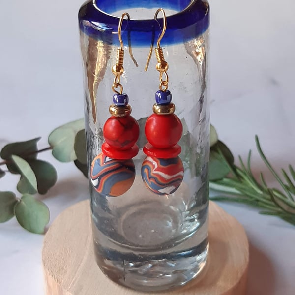 Handmade dangly polymer clay earrings  in red, blue and tangerine swirl