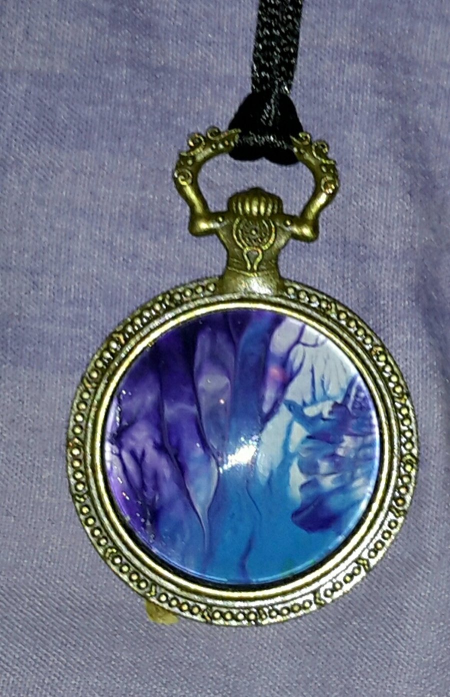 Handmade steampunk pocket watch style pendant, blue and purple.