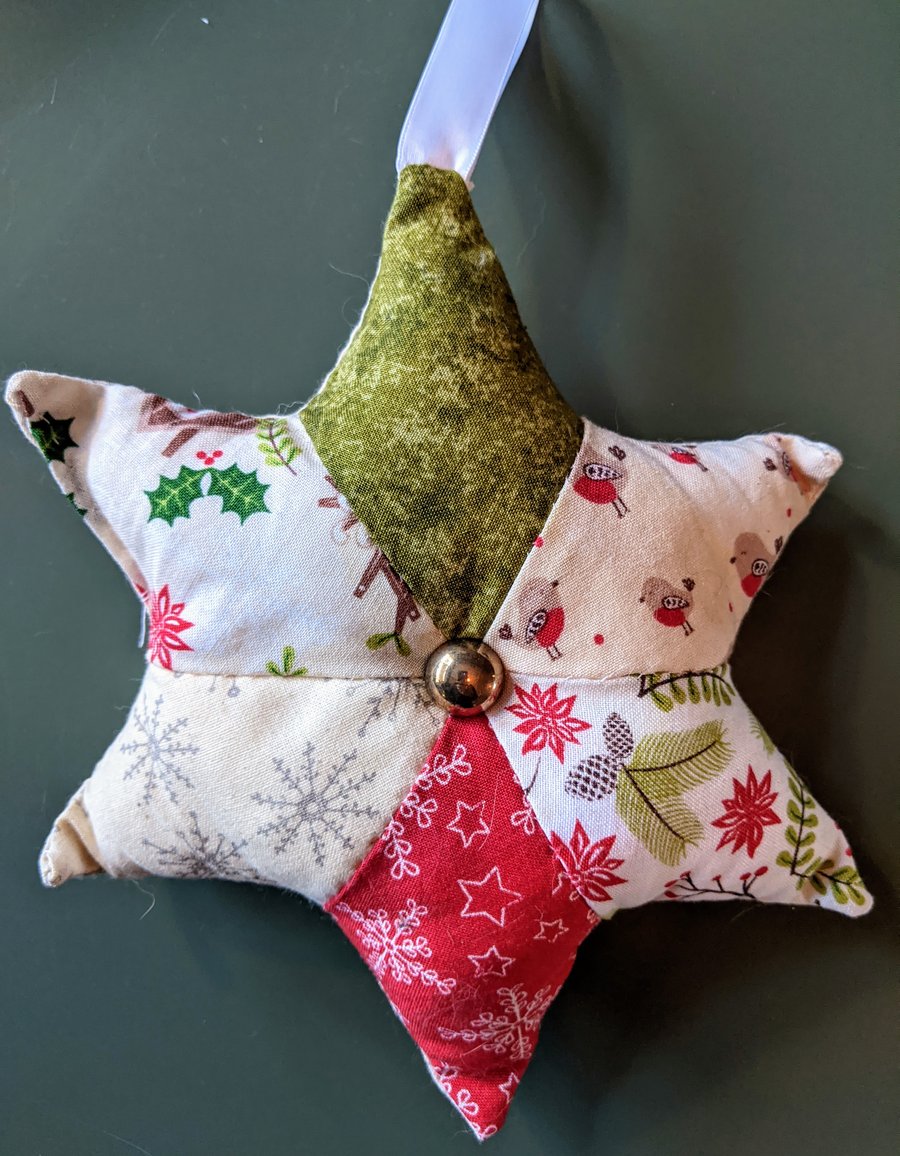 Christmas star decoration with robins, pine cones, holly, and snowflakes