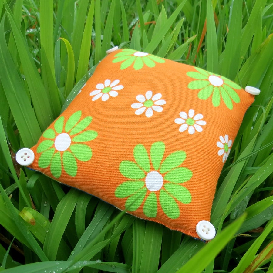 A lavender filled pin cushion.  Made from an iconic vintage flower power fabric.