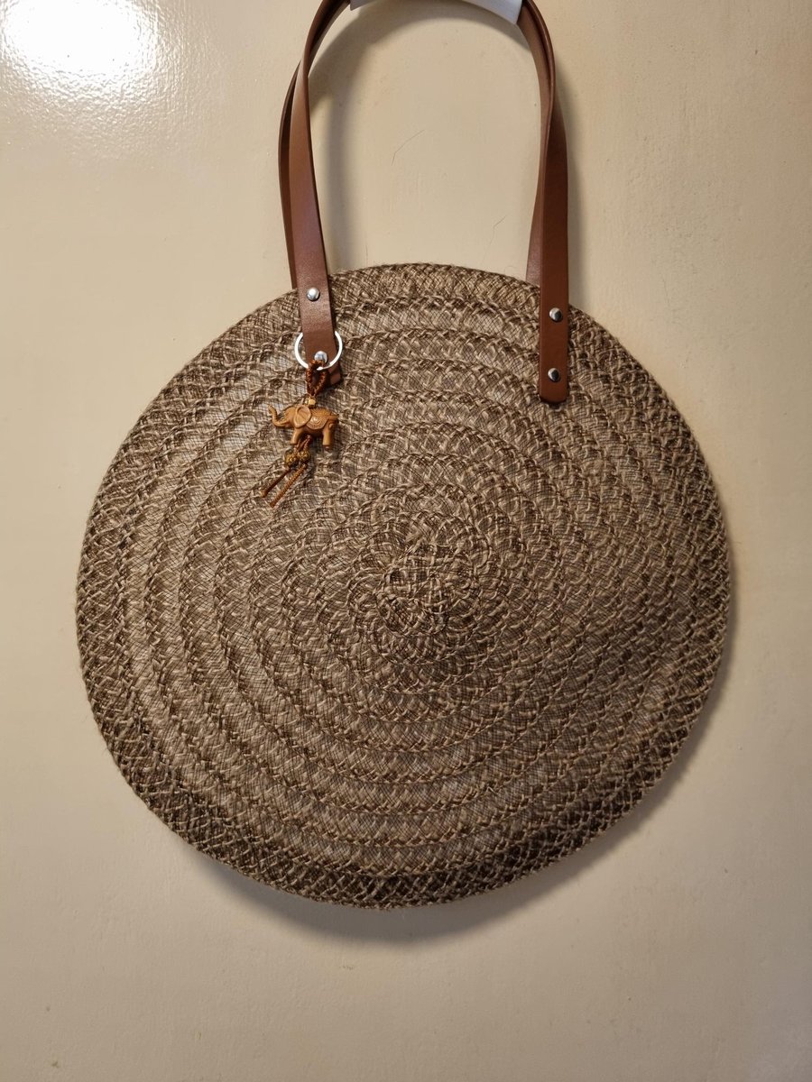 Brown Hessian rope placemat, bag with faux leather handles, and silver studs