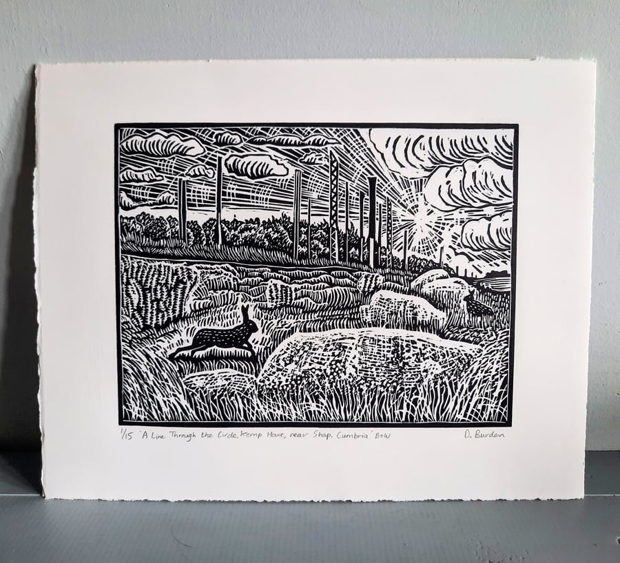 Limited edition handprinted linoprint of hares amongst ancient boulders 