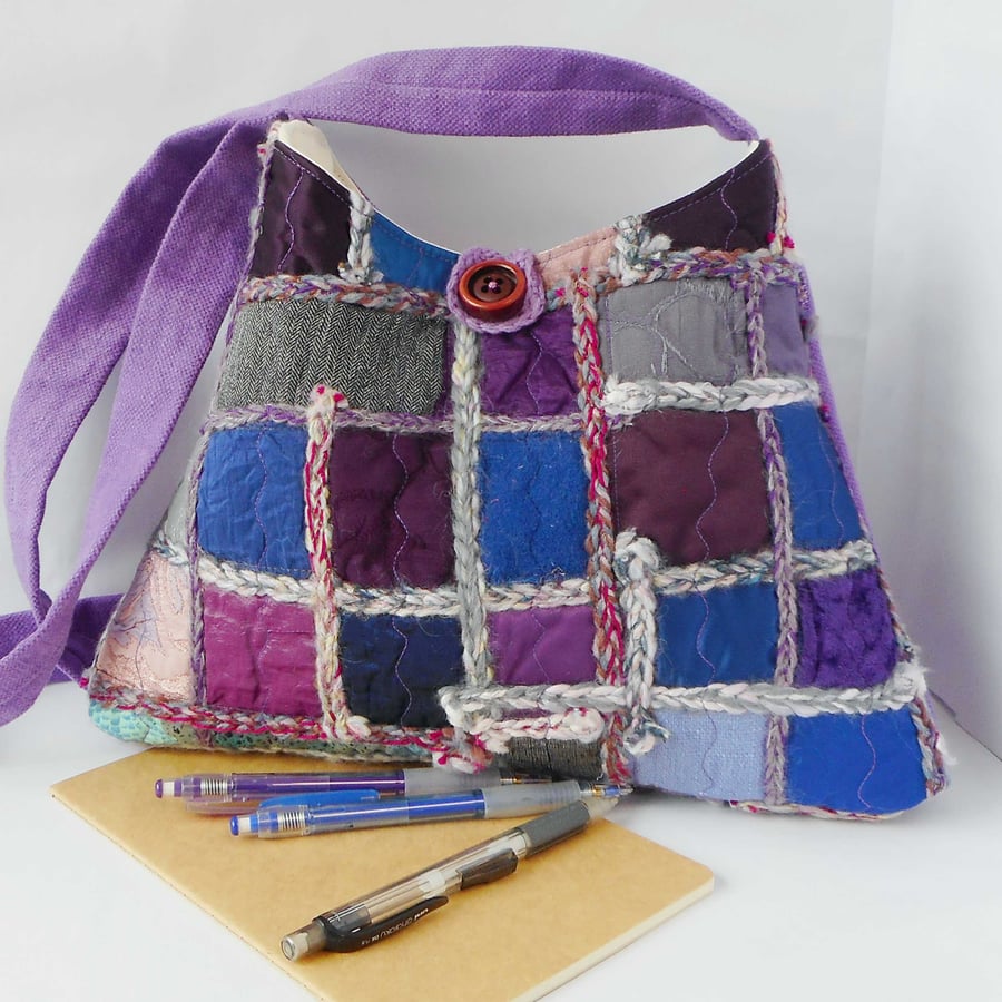 Pyramid shaped cross body shoulder bag in purple jewel tones