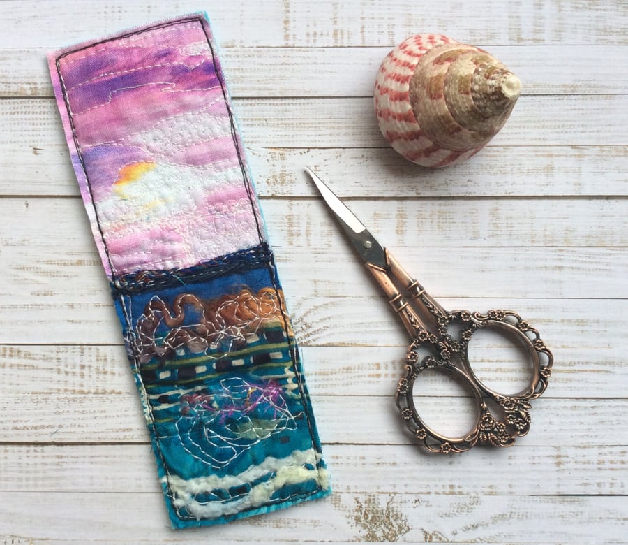 Embroidered up-cycled sunset seascape bookmark.