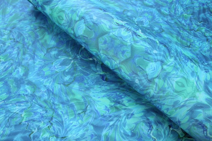 Printed marbled wrapping paper in blue green rippling water