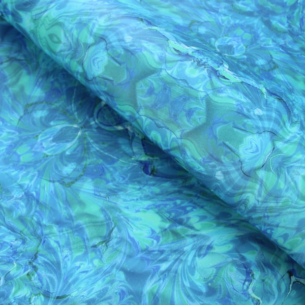 Printed marbled wrapping paper in blue green rippling water