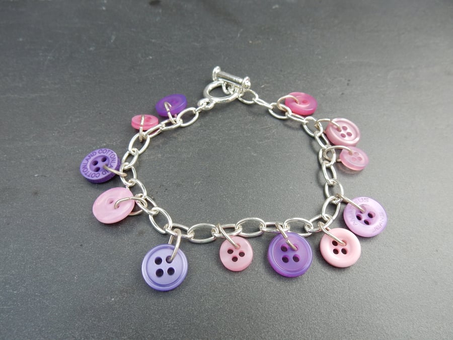 Upcycled button bracelet in shades of pink and purple