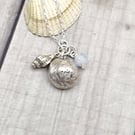 Real shells coated in silver with sea glass and bead, unique item!