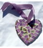A 'pretty in pink' heart shaped pendant with mauve undertones.