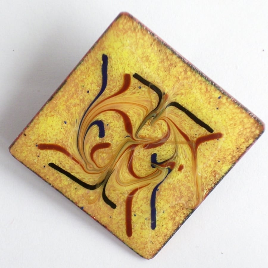 red-brown and black scrolled on gold over clear - square brooch
