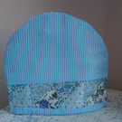 Tea cosy in blue. Patchwork border.