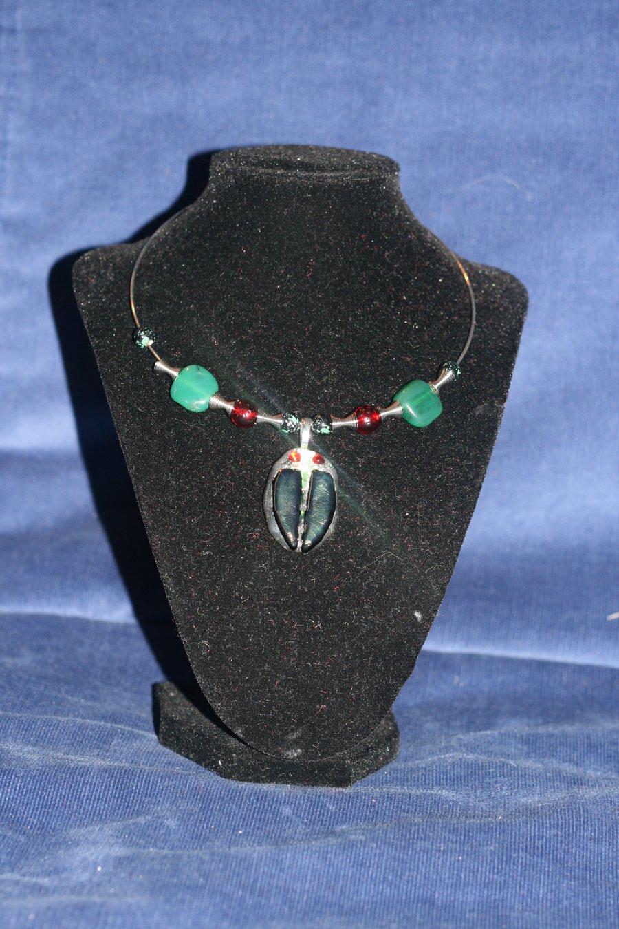 Fused glass scarab pendant on silver plated neck wire