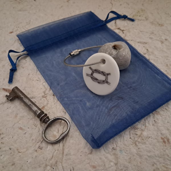Pebble keyring with a knotted rope image