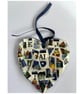 A heart shaped mosaic pendant with letters E, J, A and L, in blues and pinks.