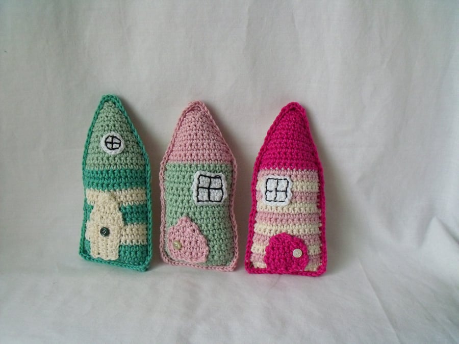 set of three crocheted cotton folk houses, pink, green, cream