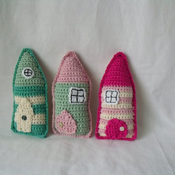 set of three crocheted cotton folk houses, pink, green, cream