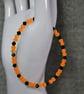 UV Reactive Orange Glass Bead and Black Glass Bicone Elastic Bracelet - Image 2