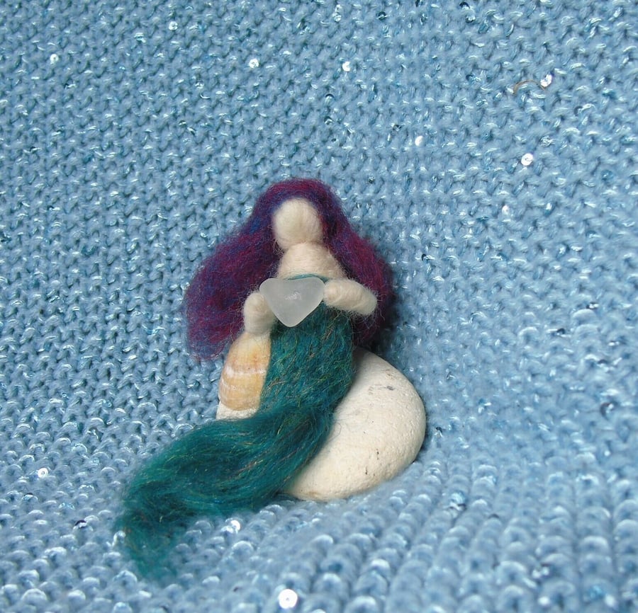 Needle felt Mermaid holding sea glass heart reclining on a shell - plaited tail