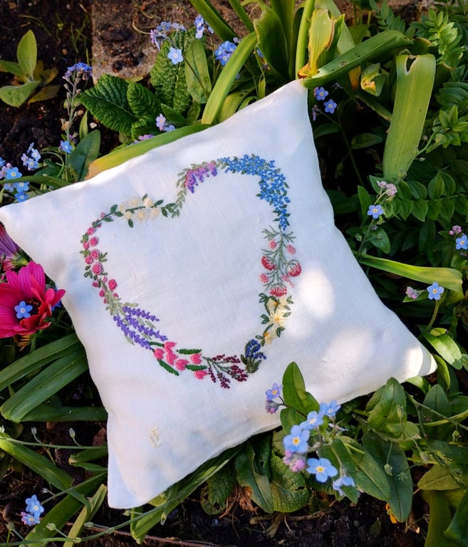 Small heart shaped, hand-embroidered linen cushion filled with lavender