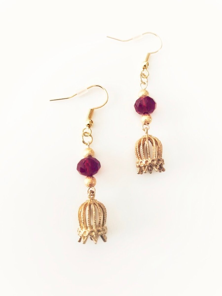 Ruby red faceted dangly glass earrings with golden beads and birdcage 