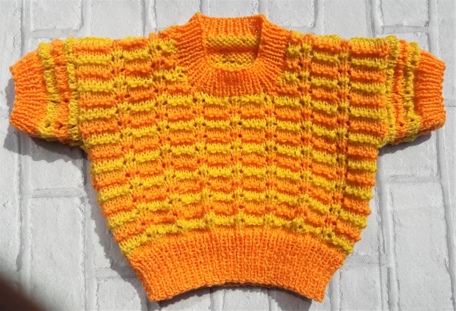 Baby sweater with knitted lace effect pattern