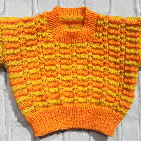 Baby sweater with knitted lace effect pattern