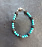 Gemstone bracelet with beads of turquoise and black lava rock - Image 1