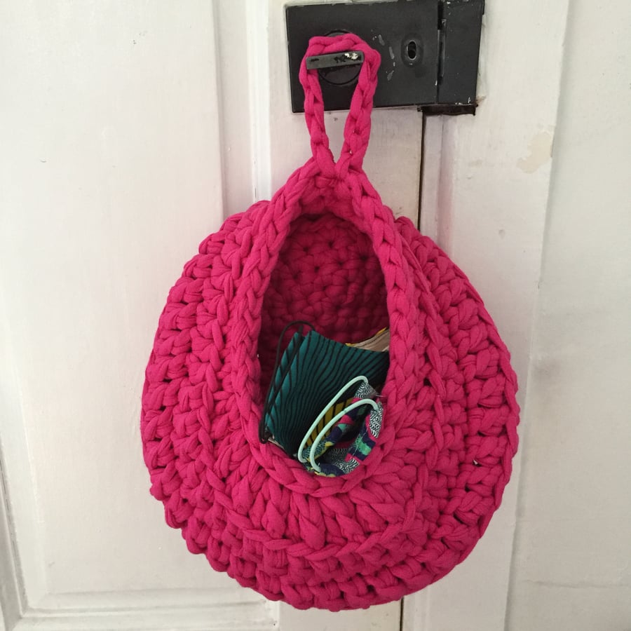 Crochet hanging basket made with upcycled tshirt yarn - bright pink
