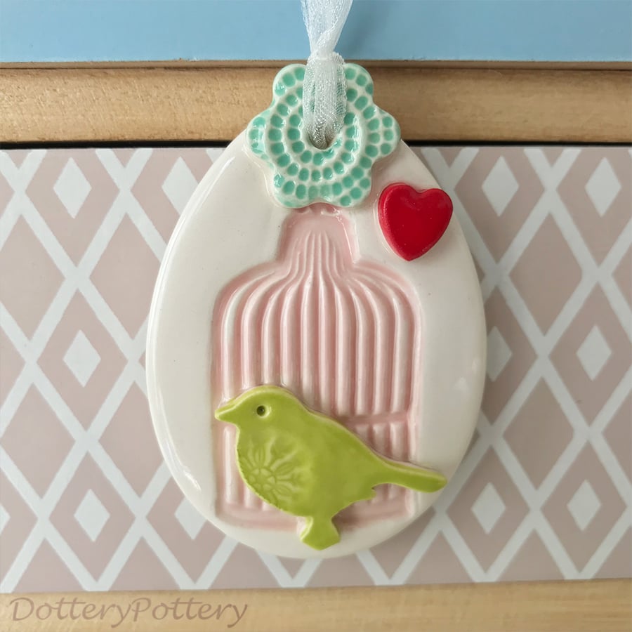 Pottery Easter Egg decoration with pink birdcage green bird and flower